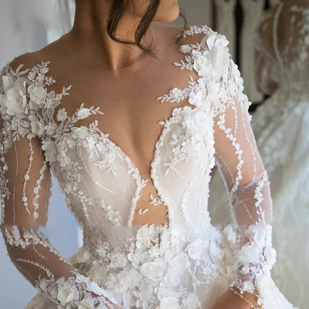 Detailed close-up of the exquisite floral lace appliques and sheer long sleeves on a luxury vintage bridal gown.