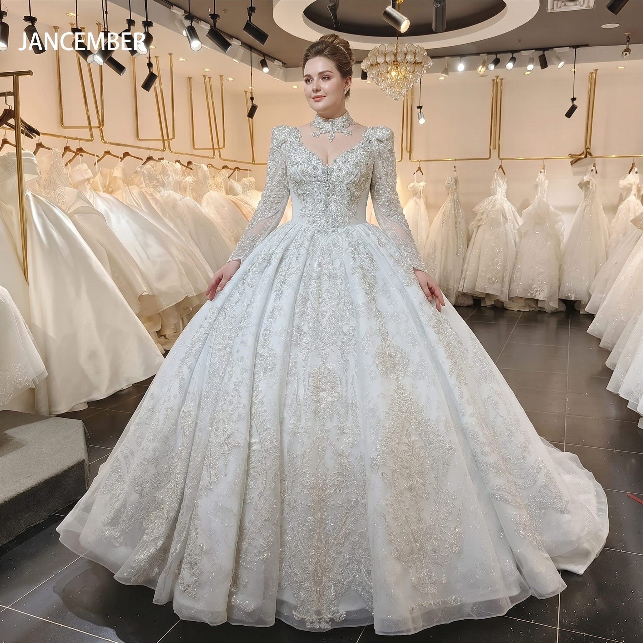 Model in a bridal boutique showcasing a luxury white long sleeve wedding dress with a heavily embroidered crystal bodice and voluminous pleated glitter skirt.