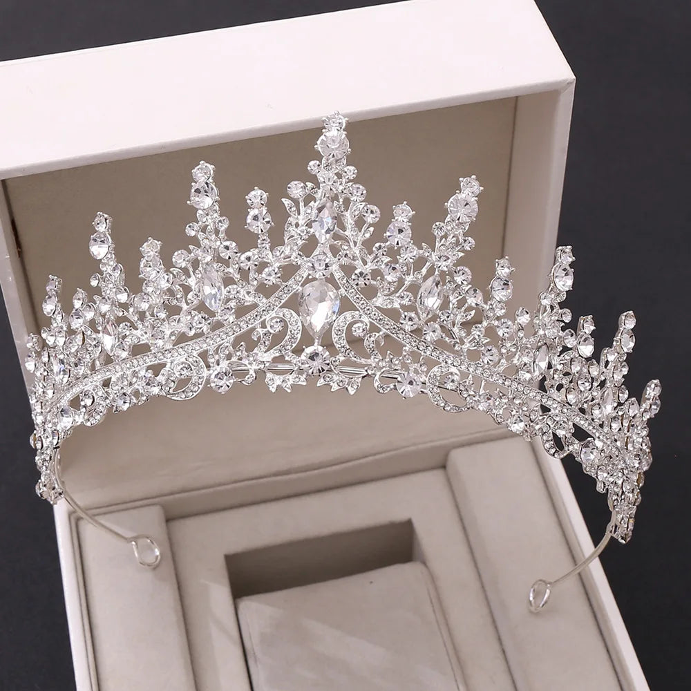 A detailed view of a silver-tone vintage luxury royal crystal wedding tiara displayed in a white gift box.