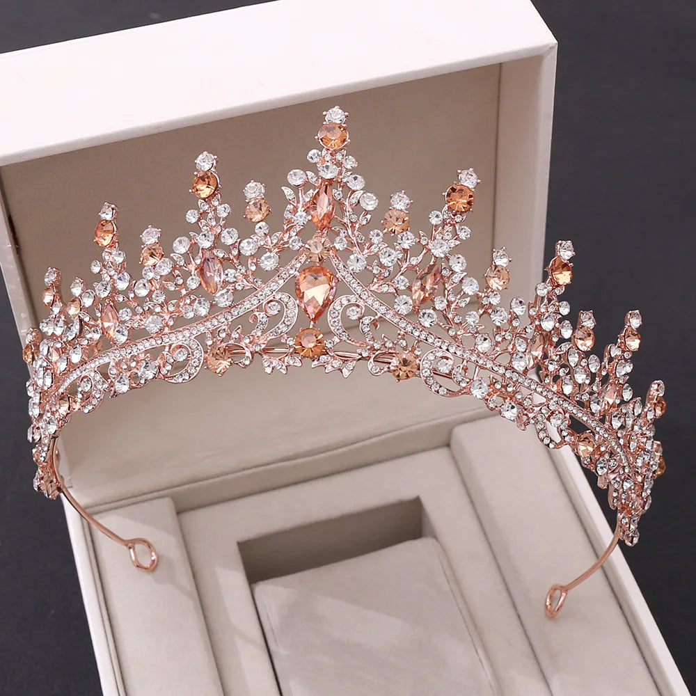 A luxury rose gold wedding tiara diadem adorned with peach-colored crystals and sparkling gems in a premium presentation box.