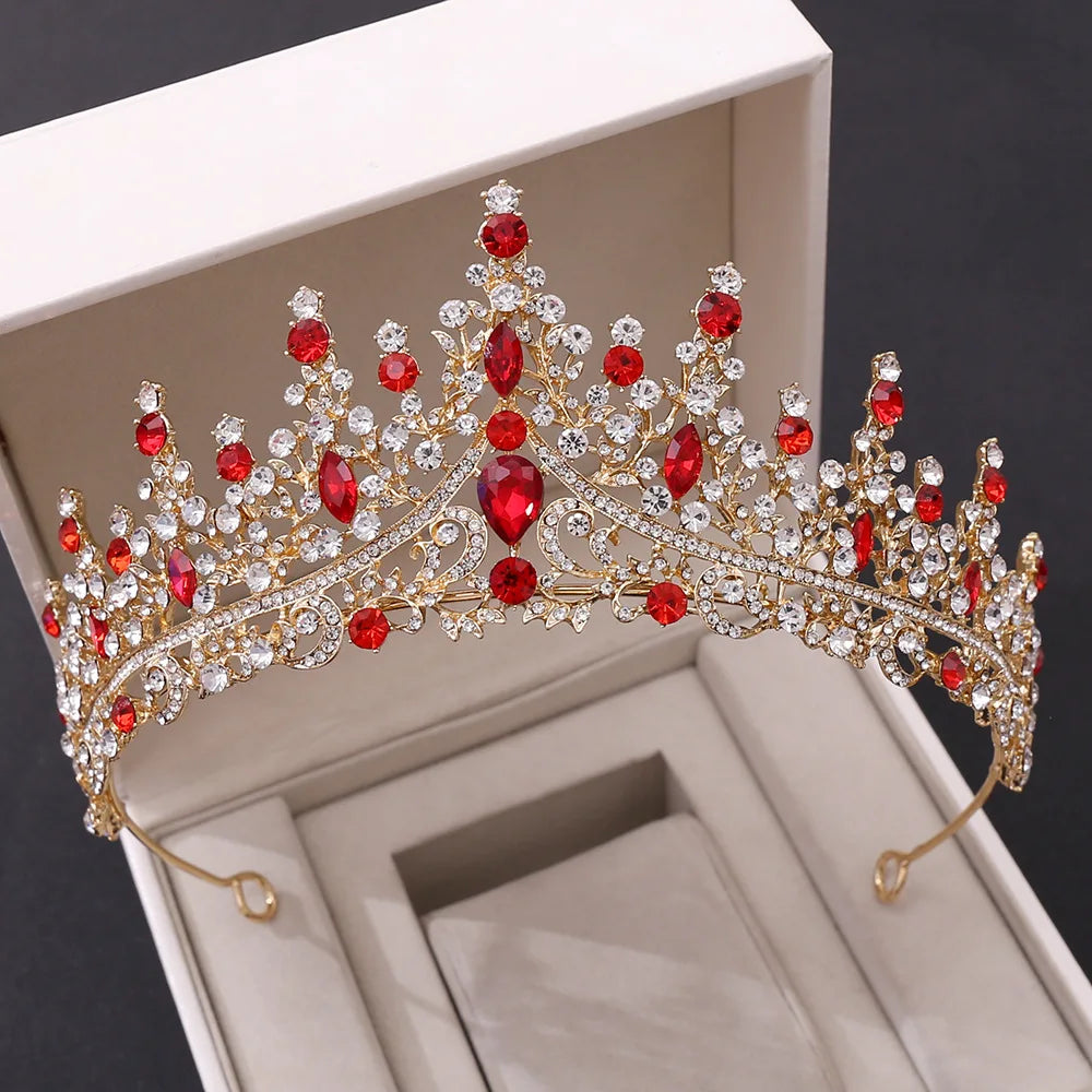 A regal gold-tone bridal crown and tiara featuring vibrant red crystal gems and intricate vintage rhinestone detailing.