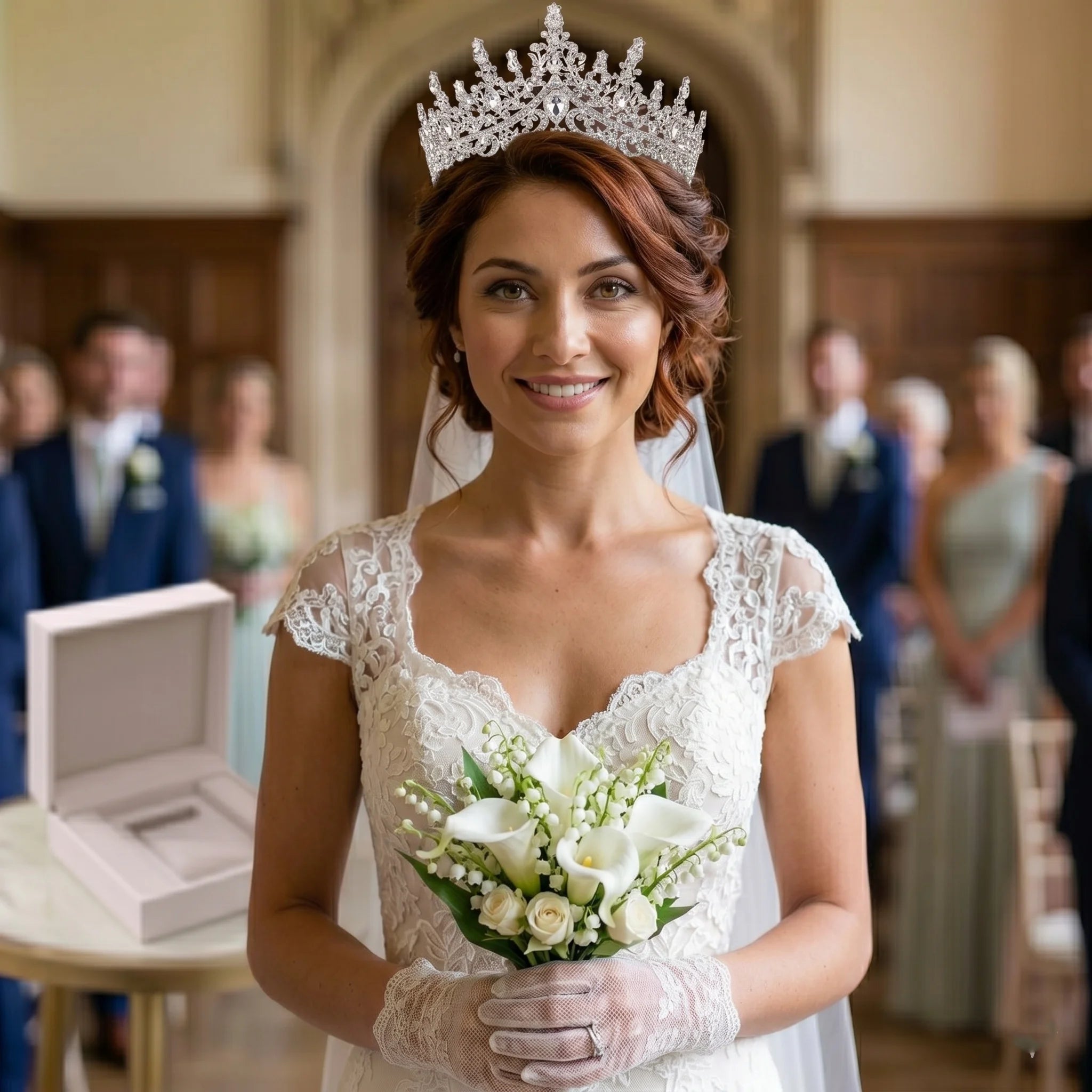 A bride wearing a vintage luxury royal crystal wedding crown and tiara, holding a bridal bouquet.
