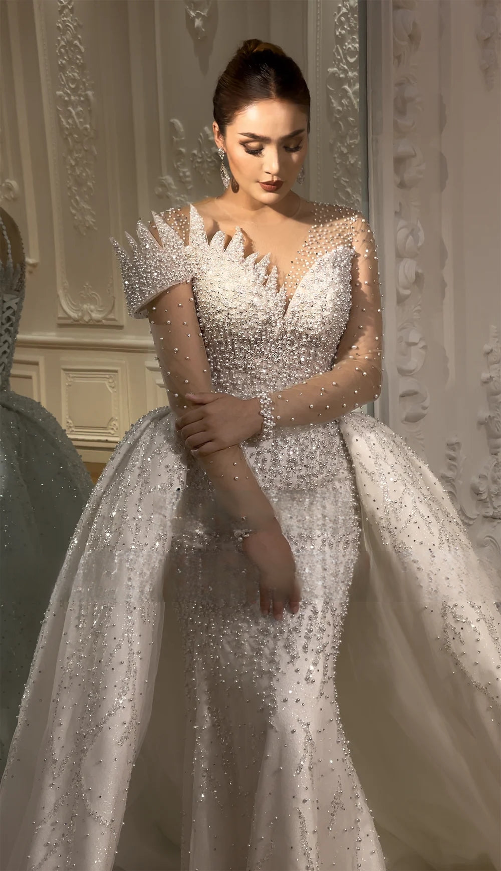 Detailed front view of the bridal bodice, showcasing a traditional lace-up corset back and delicate pearl-beaded straps.