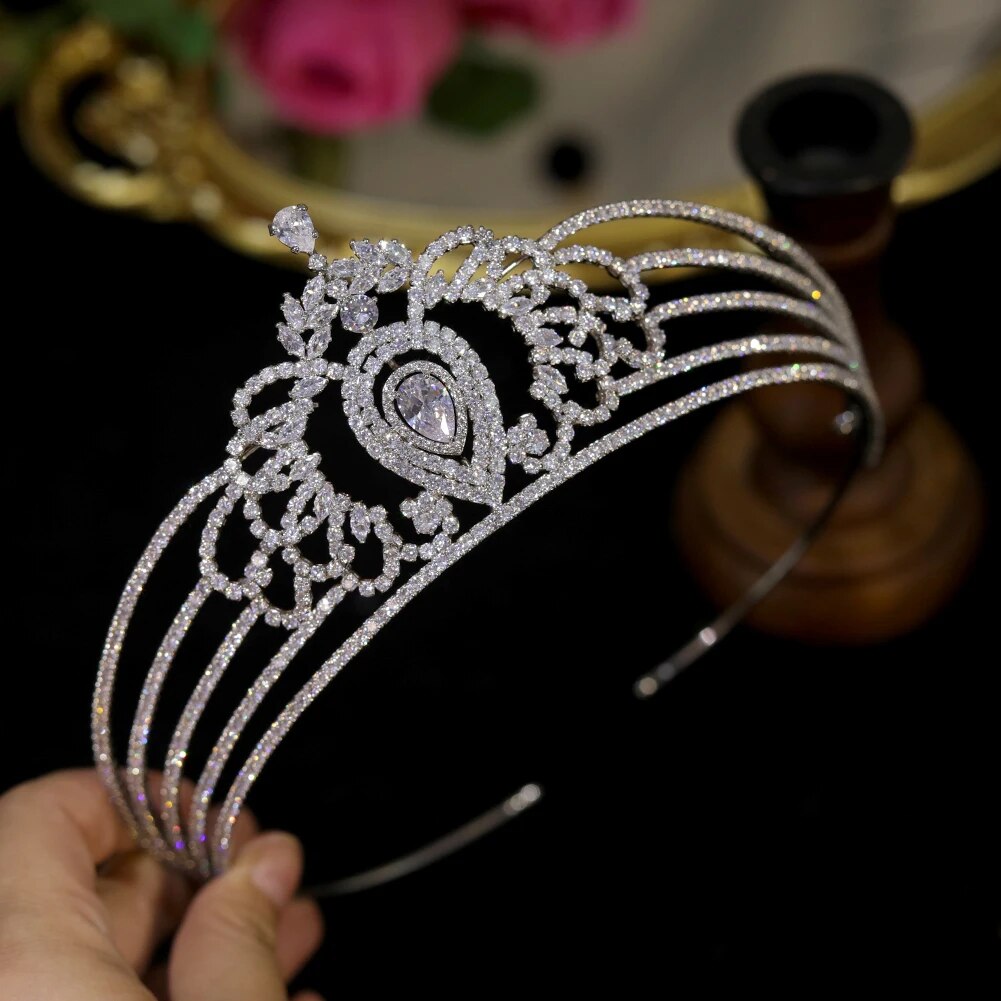 Handheld side-profile view of the premium silver bridal diadem crown highlighting five row rhinestone bands and intricate pave-set filigree arches.