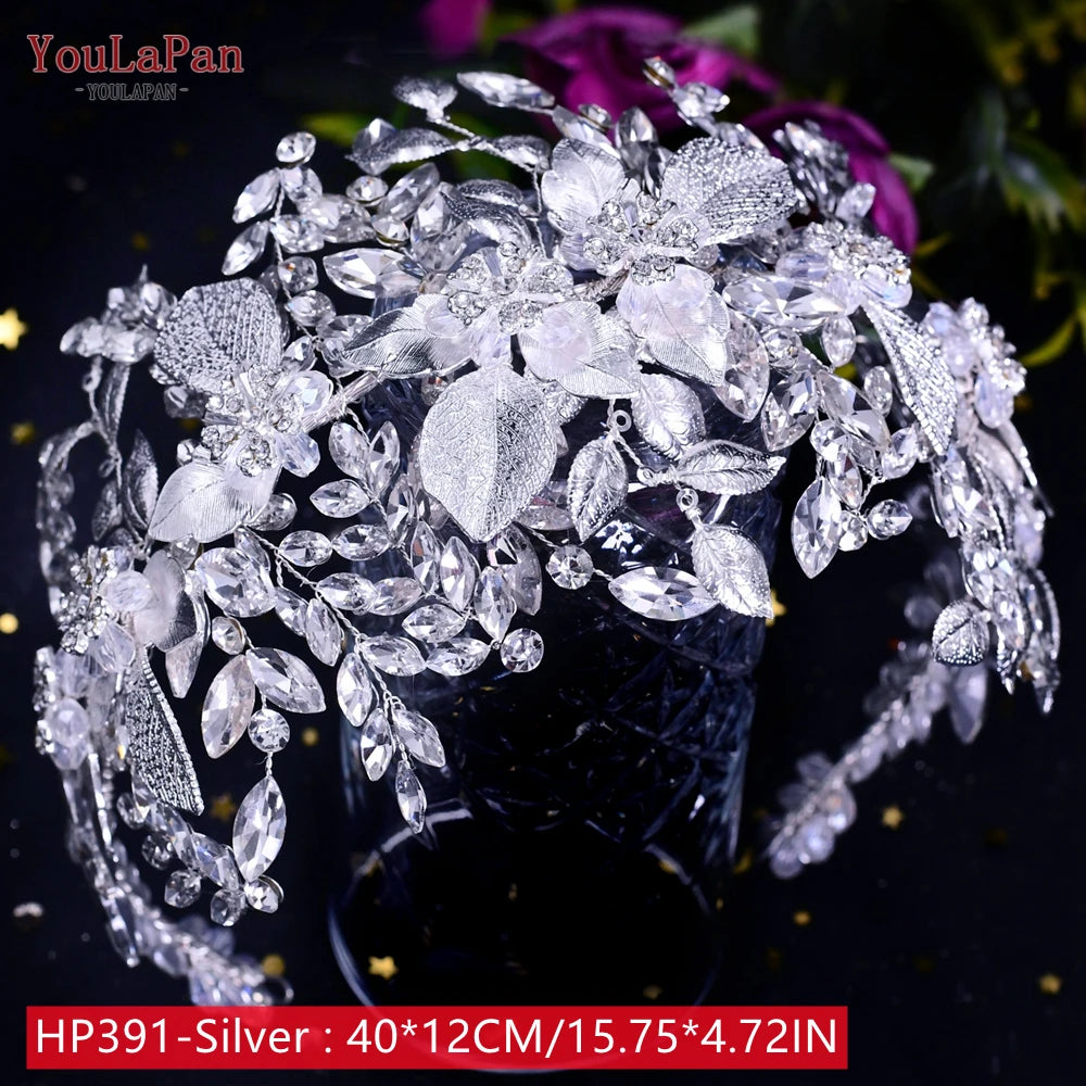 Close-up view of a luxurious YouLaPan silver rhinestone bridal tiara headpiece featuring shimmering textured metal leaves and crystal flower clusters.