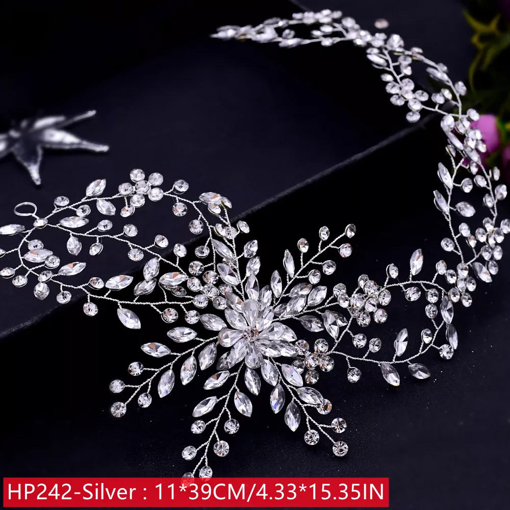 Flat lay layout of a silver bridal hair vine showing dimensions of 11 by 39 centimeters, detailed with delicate crystal wire branch sprays over a dark surface.