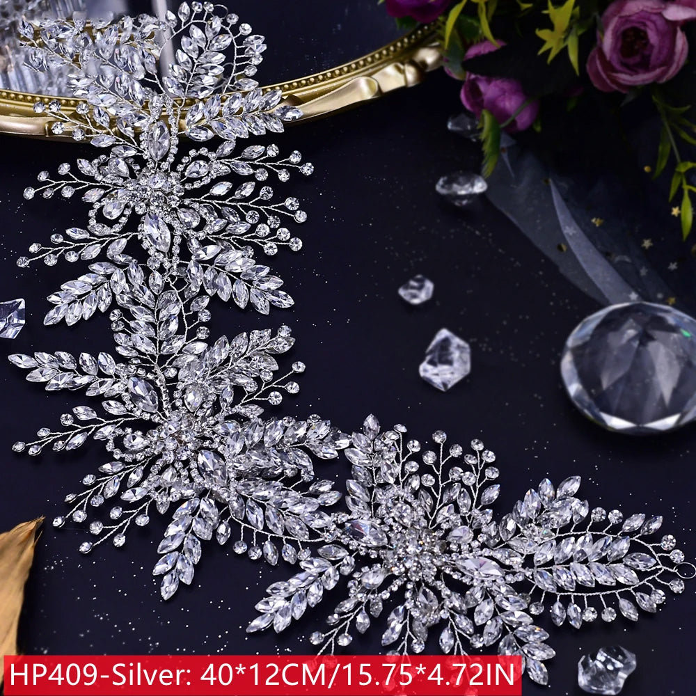 Widespread view of a premium silver-plated fashion woman tiara crown showcasing thick pave crystal leaf configurations and brilliant faceted clear stones.