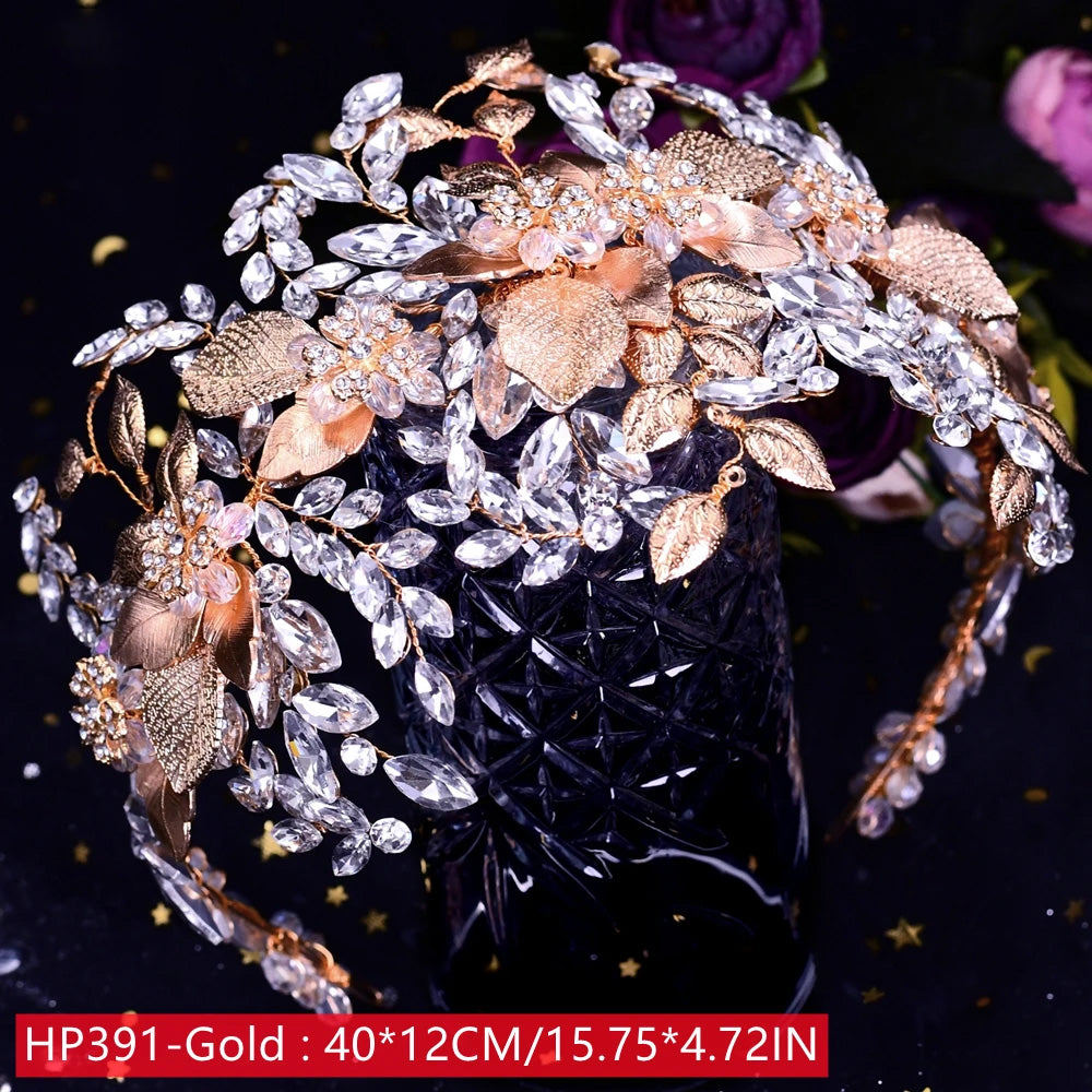 Close-up view of a luxury rose gold bridal headpiece tiara designed with textured metallic leaves, marquise-cut clear crystals, and pink enamel floral accents.