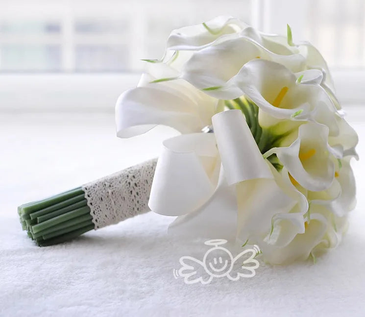 A side view of a handmade artificial bridal bouquet of white calla lilies with a lace-wrapped stem on a white background.