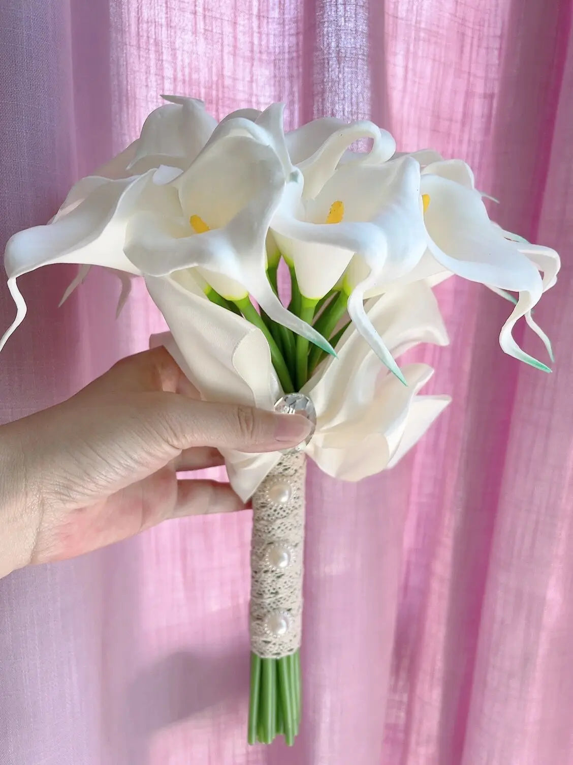 Elegant white calla lily bridal bouquet handmade with artificial flowers and a lace handle accented with pearls.