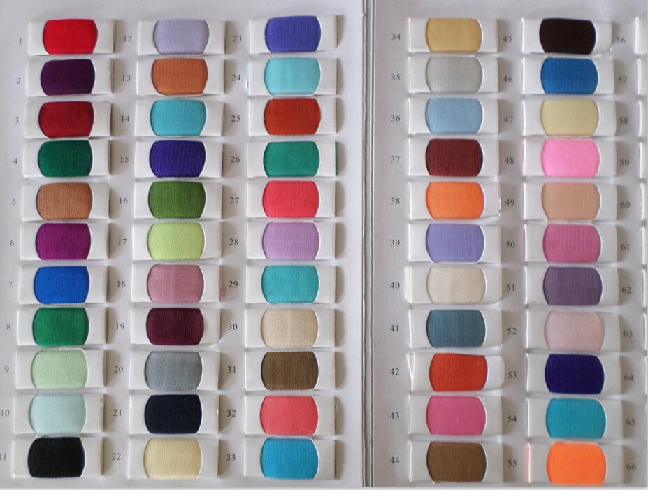 Fabric color swatch catalog displaying numbered rows of sheer mesh and tulle textile samples for custom wedding jumpsuit orders.