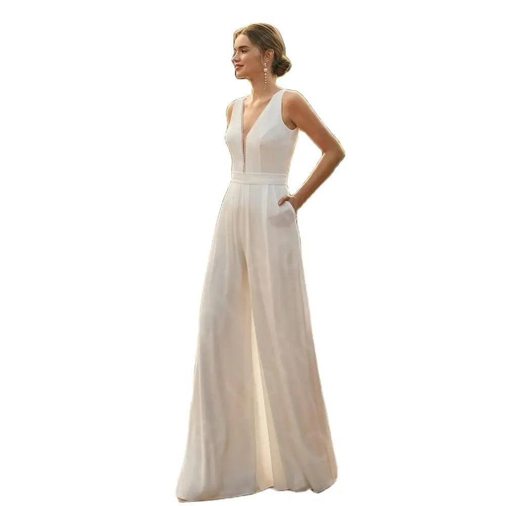 Studio product cutout on a plain white background showing the clean sleeveless silhouette of the plunge V-neck bridal jumpsuit with high-waisted wide-leg pants.