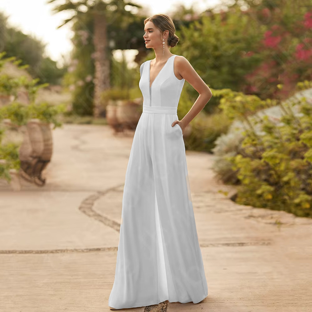 High-resolution full portrait of the modern white sleeveless V-neck wedding pantsuit, accentuating the minimalist elegant tailoring and wide-leg design.