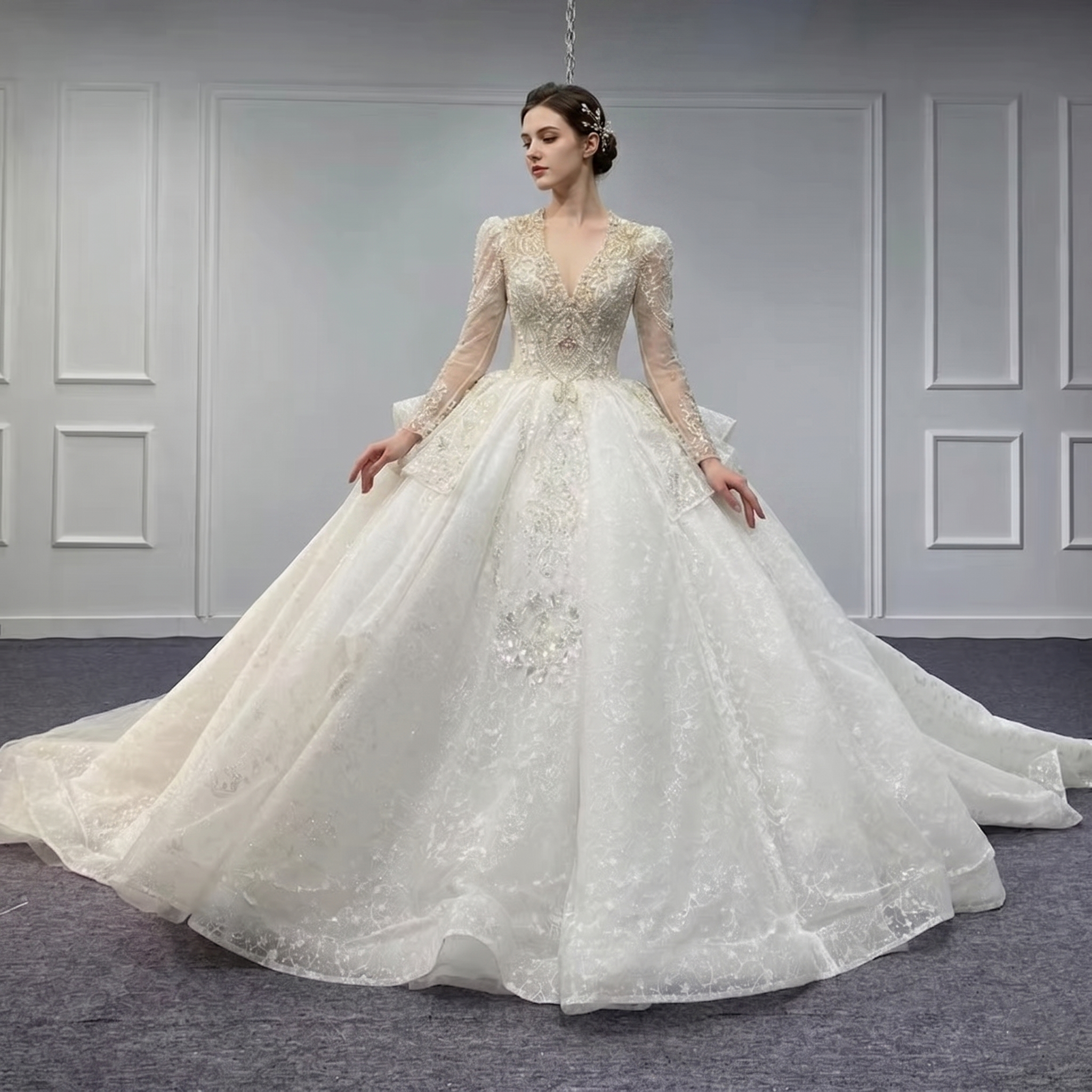 Full front view of a women's novelty organza ball gown wedding dress with full long sleeves and heavy beading, displayed on a mannequin in a bridal showroom
