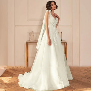 A-Line Sexy Backless V Neck Appliques Beaded Wedding Dress Luxury Spaghetti Straps Ribbons Sweep Train Bridal Gown