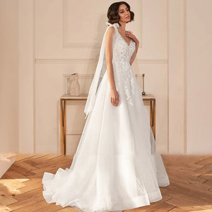 A-Line Sexy Backless V Neck Appliques Beaded Wedding Dress Luxury Spaghetti Straps Ribbons Sweep Train Bridal Gown