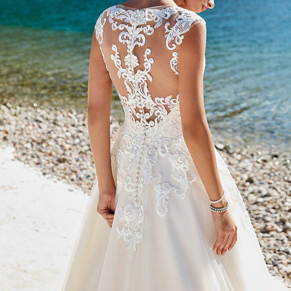 Close-up back view of a sleeveless A-line wedding dress showcasing an illusion lace back with delicate button closures.
