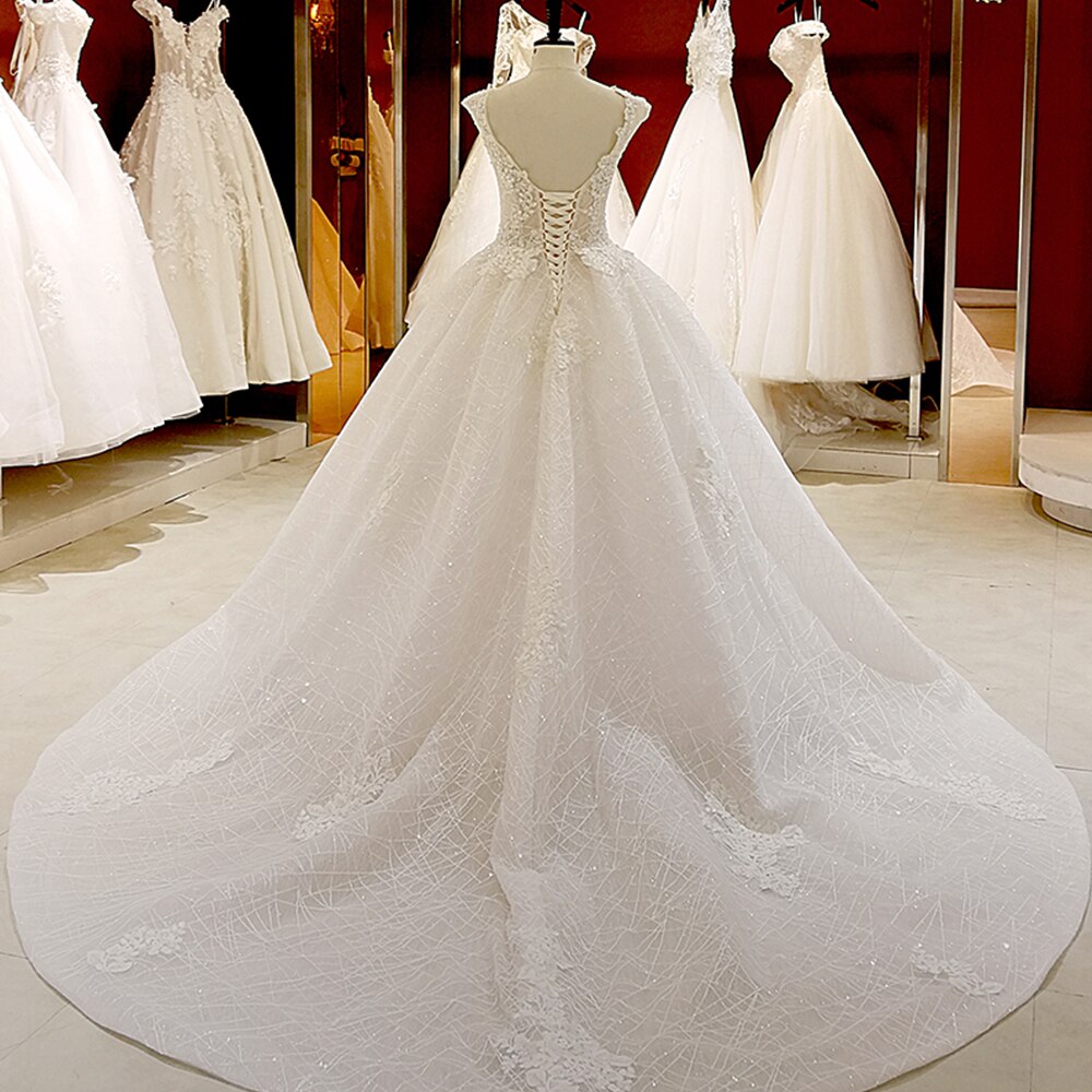 Front view of a princess ball gown wedding dress, highlighting the detailed V-neck bodice and tulle skirt.