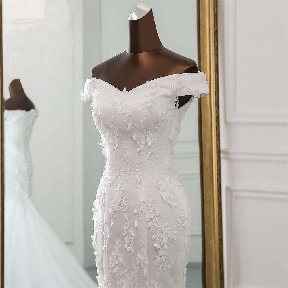 Elegant off-shoulder mermaid wedding dress with a sweetheart neckline, shown on a mannequin with classic styling.