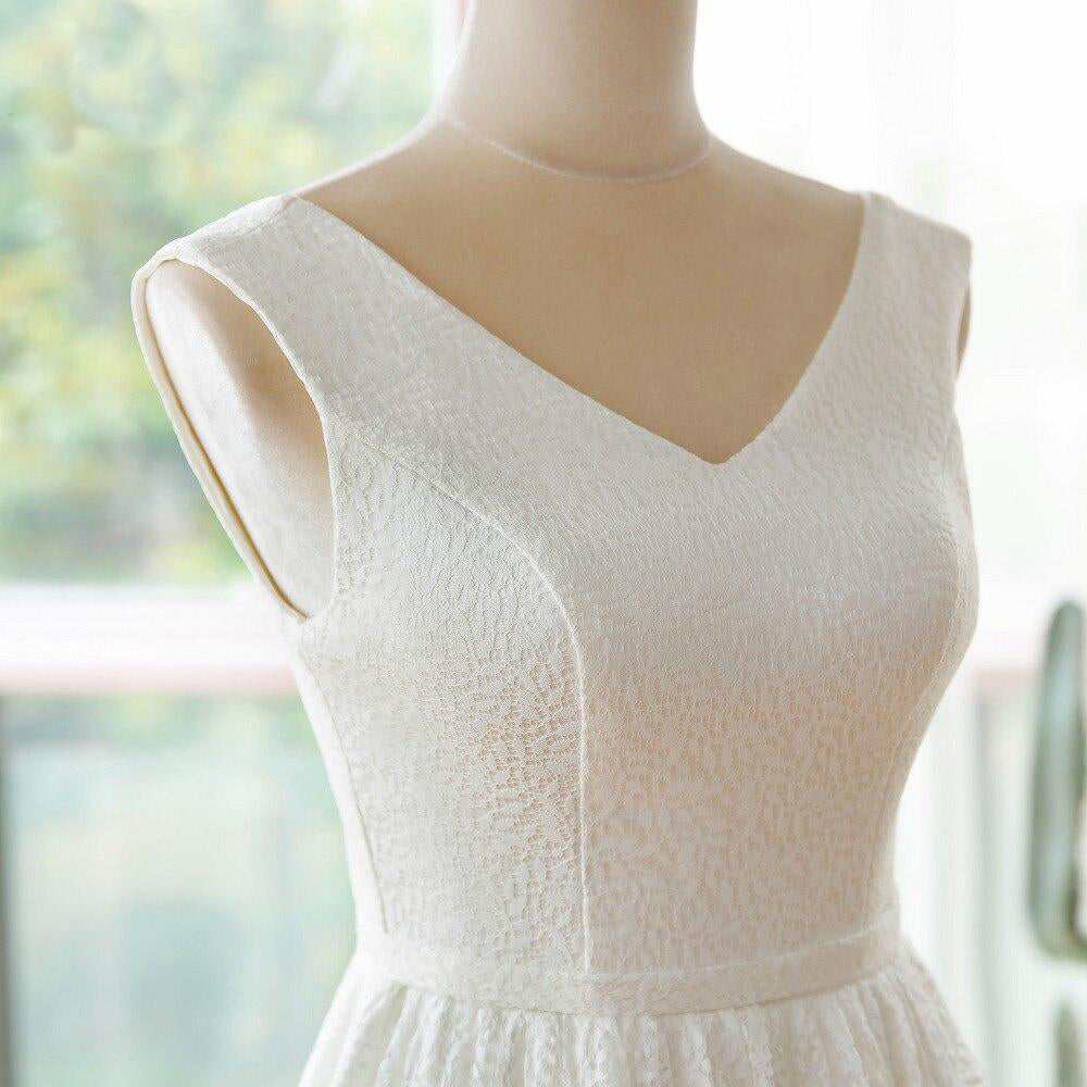 Detailed close-up of the bodice on an elegant V-neck lace wedding dress featuring delicate textures.