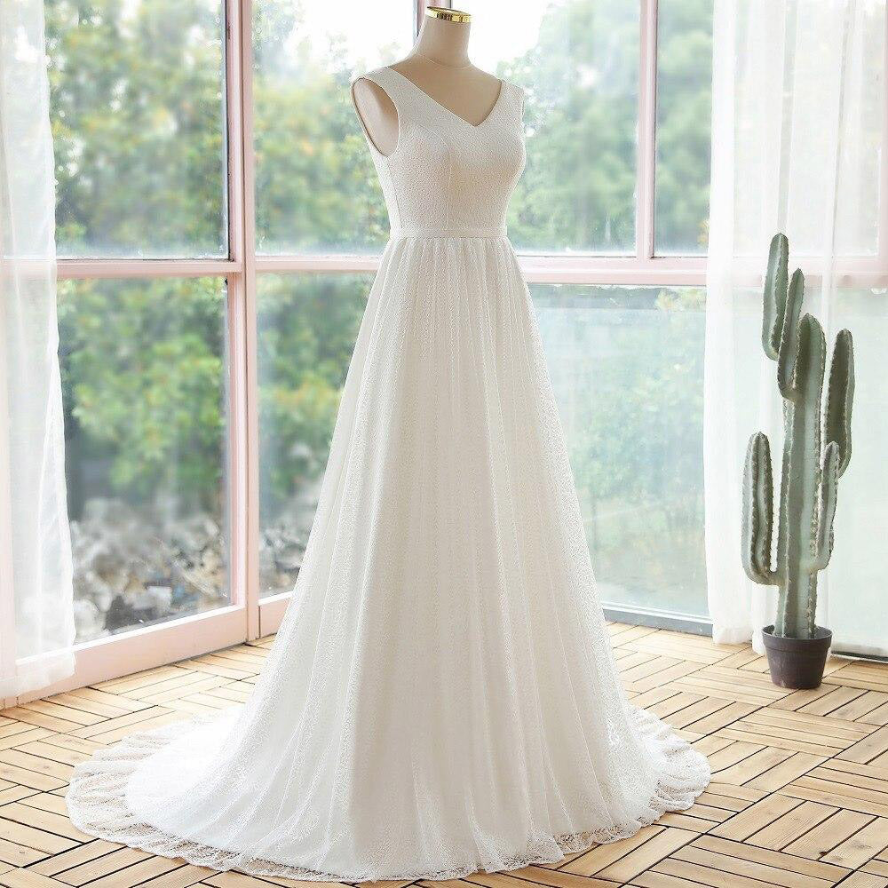 Side profile view of a lace A-line bridal gown showcasing the V-neckline and flowing silhouette.