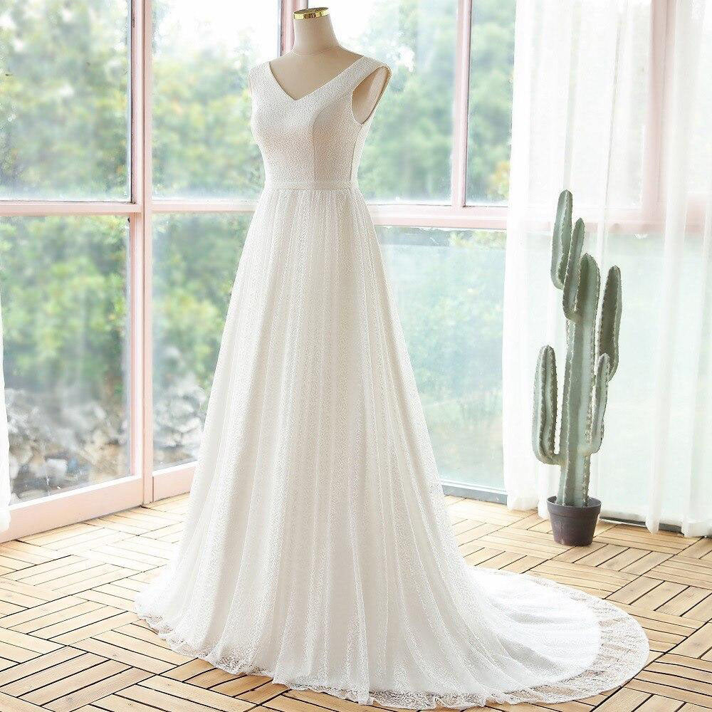 Full front view of a white lace A-line wedding dress with a V-neck, displayed on a mannequin.