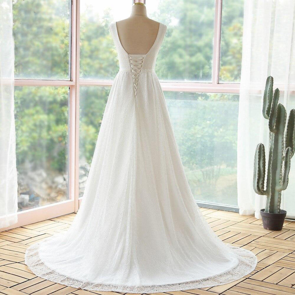 Rear view of the elegant lace A-line wedding dress featuring a corset-style lace-up back and flowing train.