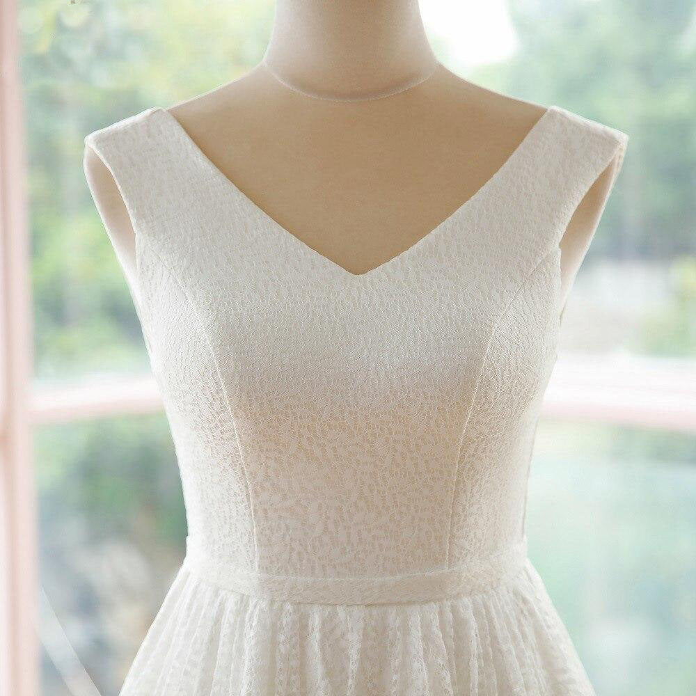 Close-up of the bodice and V-neckline of an elegant A-line lace wedding dress.
