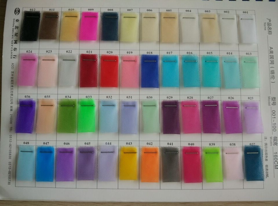 A detailed color palette chart showcasing various colorful tulle swatches available for designing custom evening and wedding dresses.