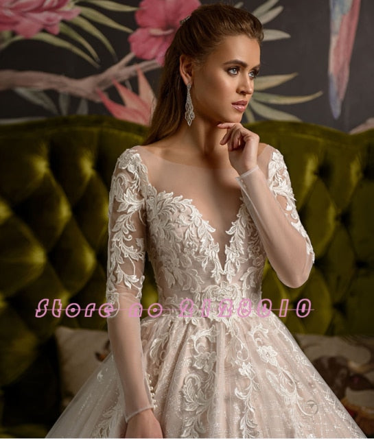Detailed side profile of the bride in a long-sleeve lace wedding dress, focusing on the sheer illusion neckline and bodice embroidery.