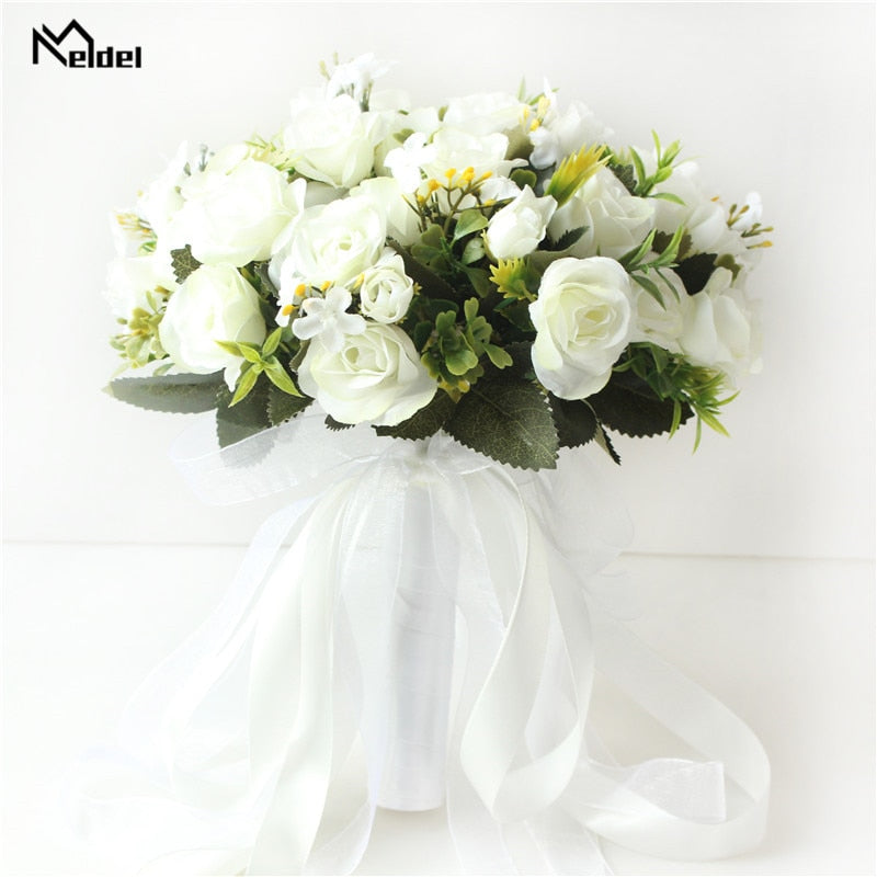 Front look at a pure white silk rose wedding bouquet by brand Meldel, featuring a handle wrapped in pristine white satin and sheer organza ribbons.