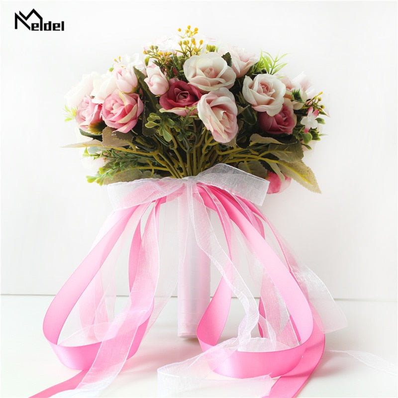 Side perspective of a premium artificial flower wedding bouquet featuring deep pink, mauve, and cream silk roses with trailing hot pink satin ribbons.