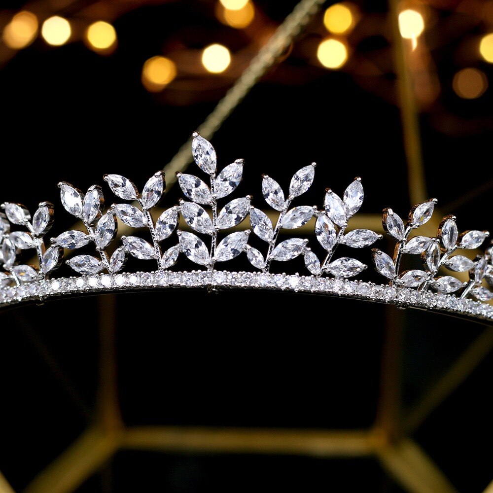 Extreme close-up shot focusing on the central peak of the silver leaf wedding tiara headband, showcasing the fine pave stone settings on the base band and brilliant clarity of the crystal leaves.