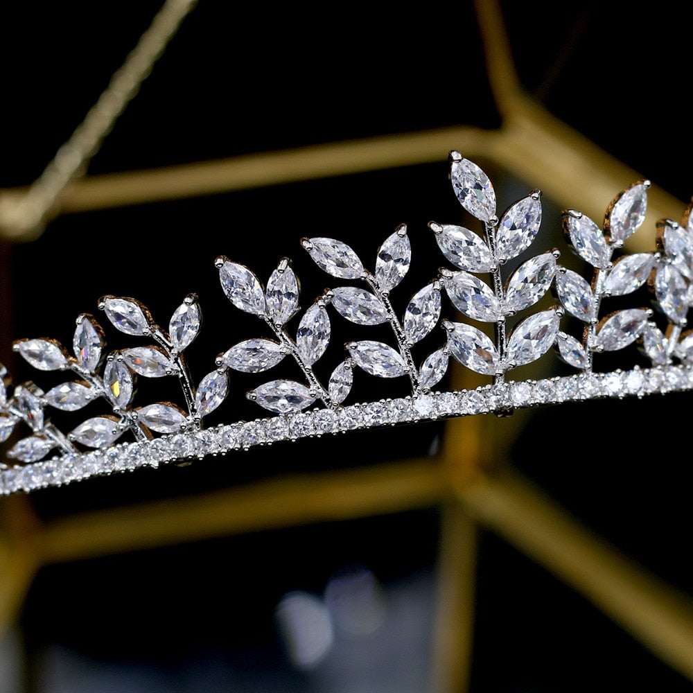 Macro photograph highlighting the meticulous wirework and stone setting details on a section of the premium leaf bridal wedding tiara crown over a dark, out-of-focus background.