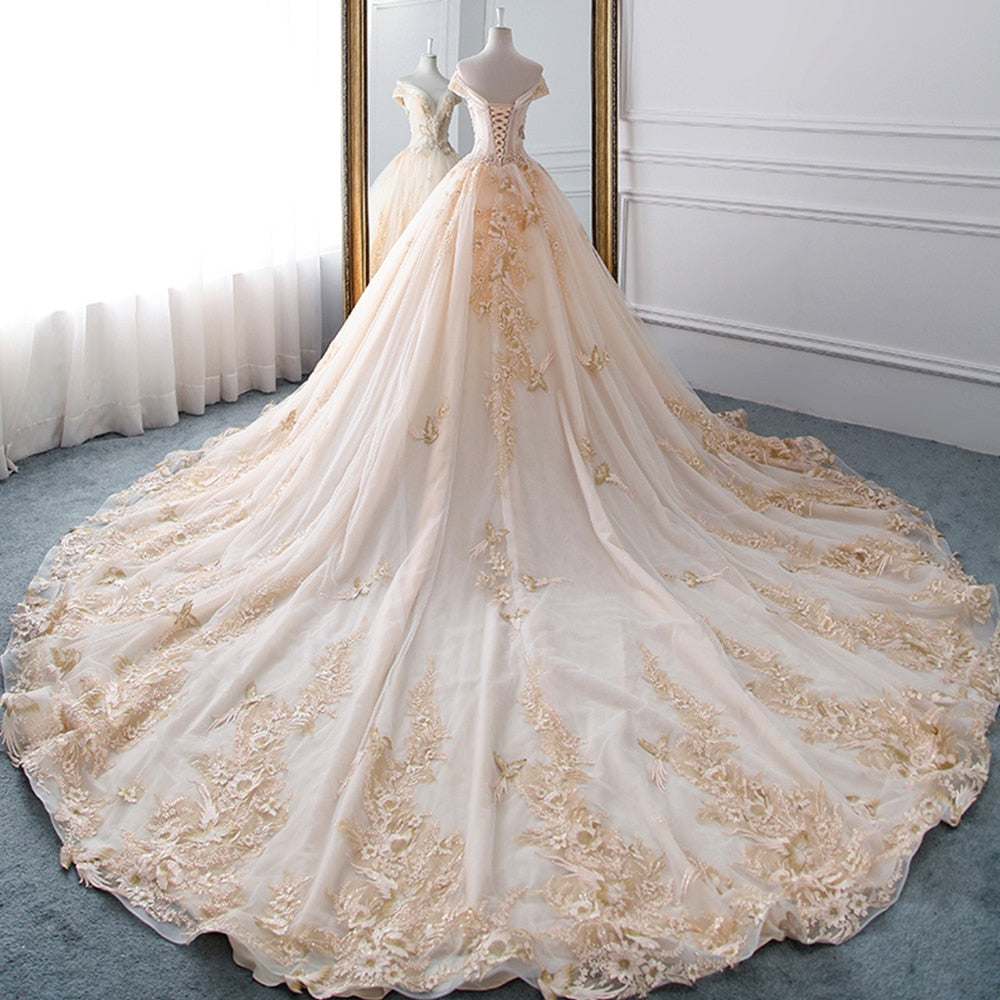 Close-up of the elaborate beaded and pearl-embellished embroidery on the skirt of a luxury ball gown wedding dress.