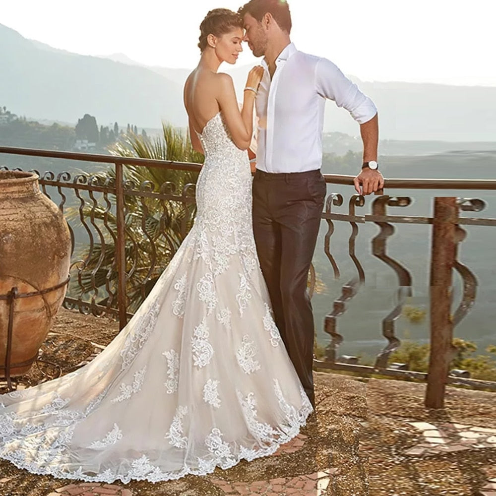 Elegant portrait of a bride in a sweetheart-neckline mermaid wedding dress on an outdoor terrace.