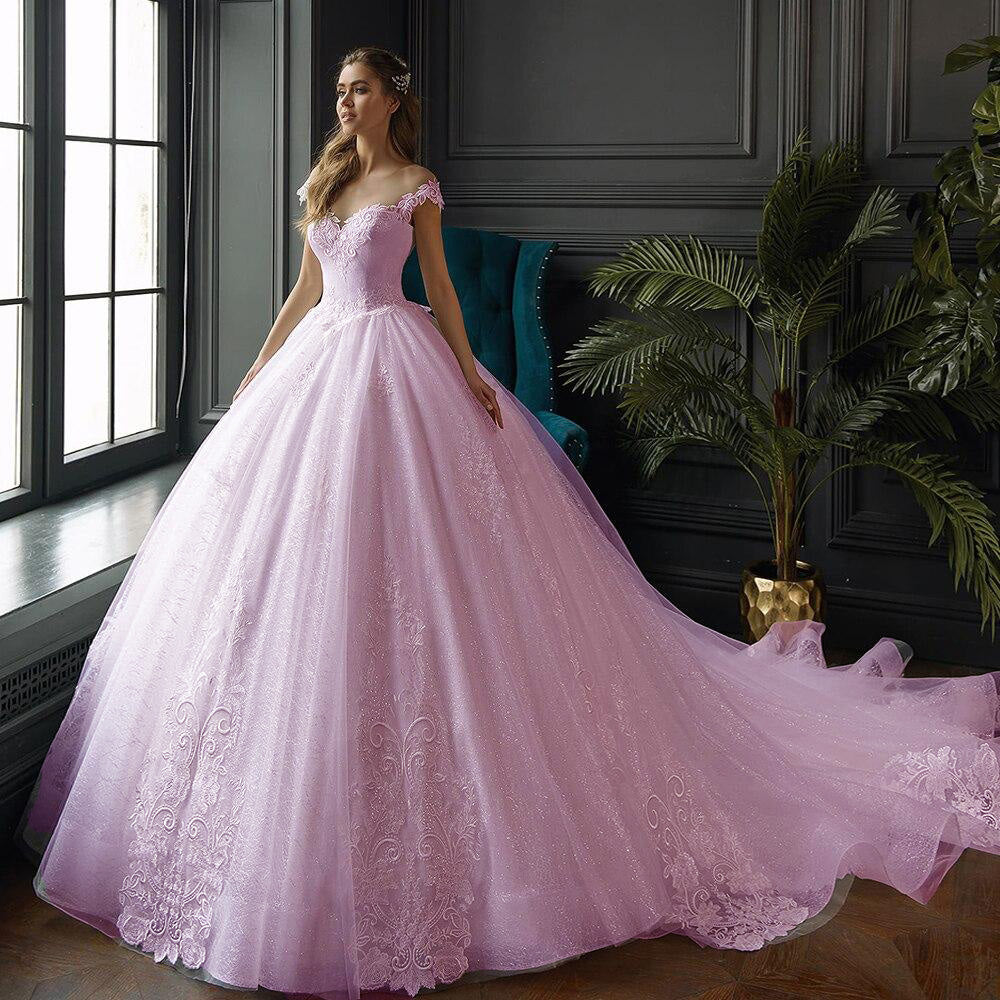 Pink Side view of a bride wearing a shimmering princess ball gown, highlighting the elegant design and voluminous skirt.