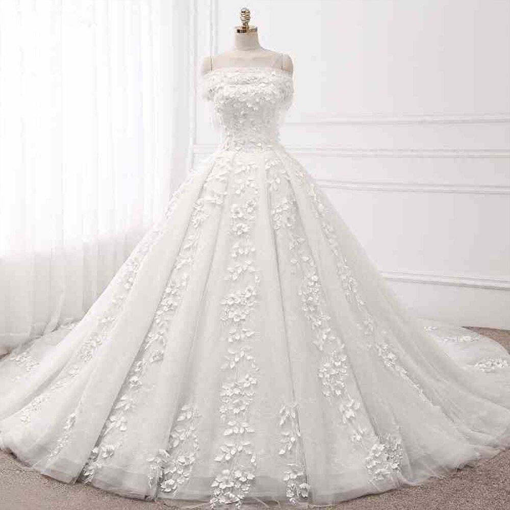 Elegant princess ball gown wedding dress on a mannequin, showcasing a structured bodice, off-the-shoulder neckline, and full tulle skirt.