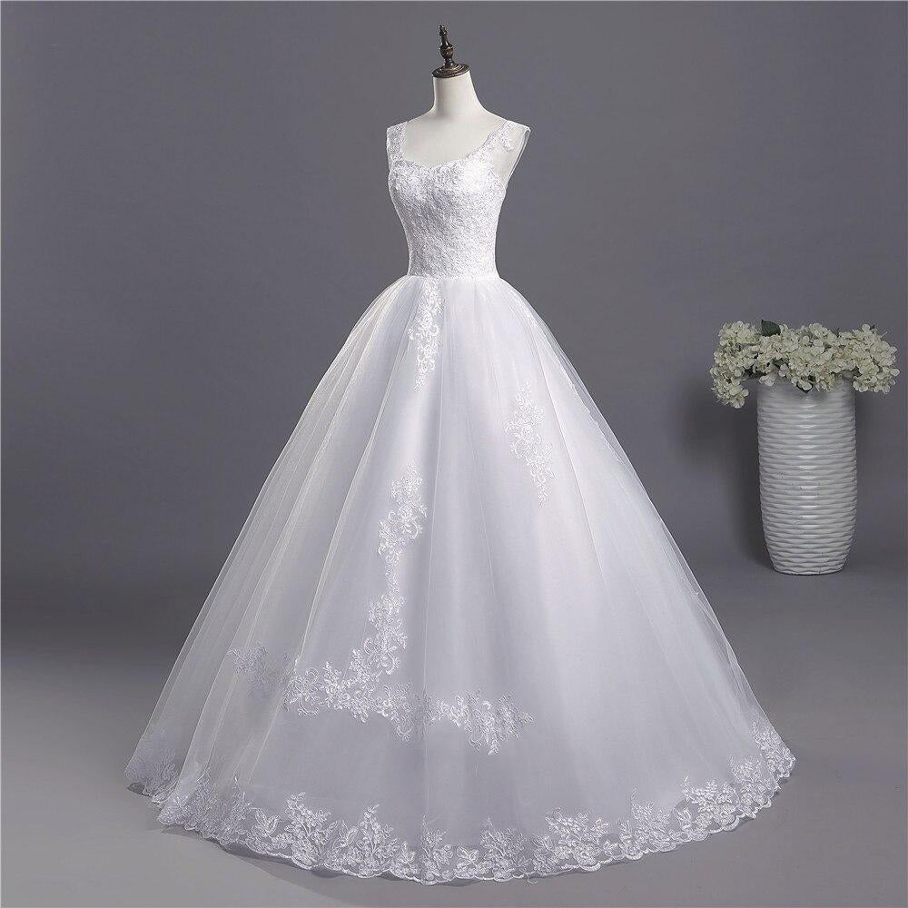 Side-angle view of a sophisticated A-line bridal gown featuring a fitted lace bodice and full skirt