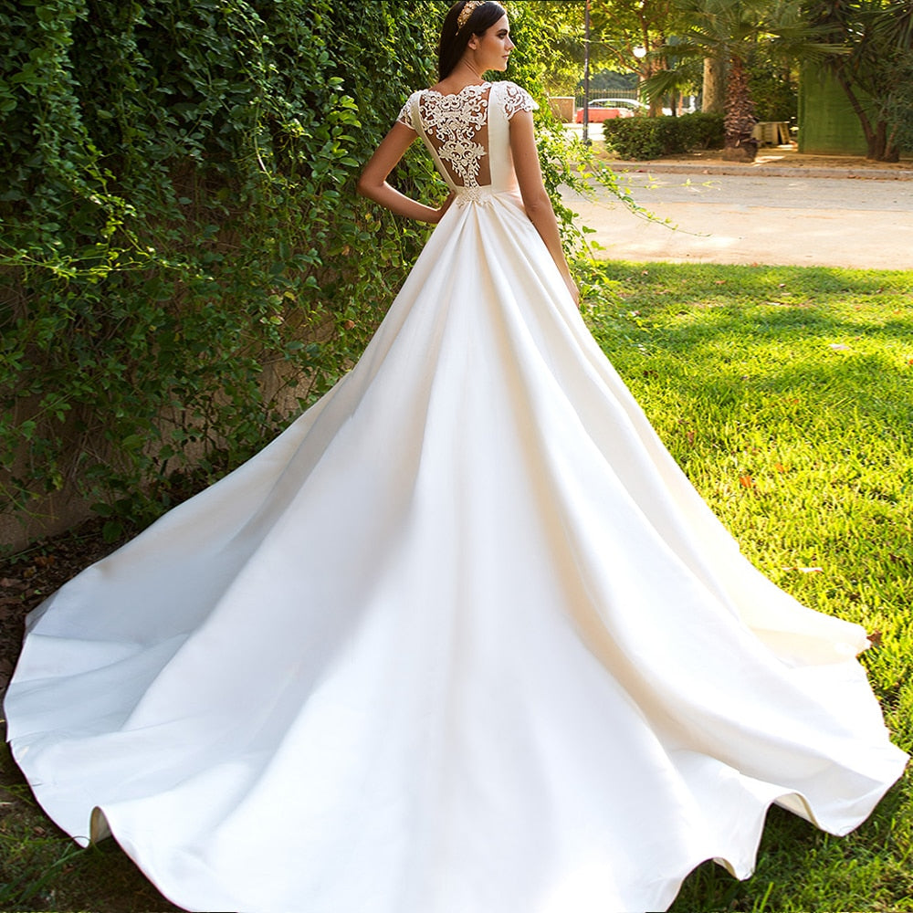 Plus-size princess ball gown wedding dress featuring off-the-shoulder sleeves and intricate three-dimensional floral lace detailing.